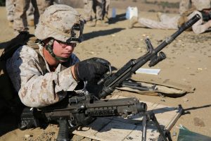 MARINE CORPS BASE CAMP PENDLETON, Calif. – Lance Cpl. Ben Aloia, a rifleman with Alpha Company, 1st Battalion, 1st Marine Regiment, and a native of Denver, changes a barrel on an M249 Squad Automatic Weapon during a live-fire exercise on Range 222 here, Sept. 5, 2013. The Alpha Co. Marines fired Mk-19 grenade launchers, .50 caliber machine guns, SAWs and M240B medium machine guns Sept. 4 and 5 to crosstrain and refine their skills with each weapon system. Throughout the two days of shooting, the Marines were evaluated as they engaged multiple targets with each weapon system at ranges of 400 to 1,200 meters away.