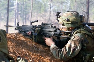 A US Army (USA) 1st Brigade, 25th Infantry Division (Light), Soldier wearing Multiple Integrated Laser Engagement System (MILES) gear aims down range with his 5.56mm M249 Squad Automatic Weapon (SAW) during live fire exercises at the Joint Readiness Training Center (JRTC), Fort Polk, Louisiana (LA).