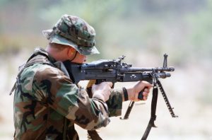 A Sea-Air-Land (SEAL) team member fires an M60 lightweight machine gun from the shoulder during a field training exercise.