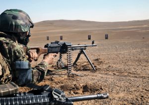Afghan National Army Capt. Raheem working with Fox Company, 2nd Battalion, 1st Marine Regiment, Regimental Combat Team 1, fires his Russian PKM during a range in Garmser, Afghanistan, Feb. 15, 2011. Fox Company conducted the range with their Afghan National Army partners to familiarize them with their weapons and provide useful training. (U.S. Marine Corps photo by Cpl. Brice D. Sparks/Released)
